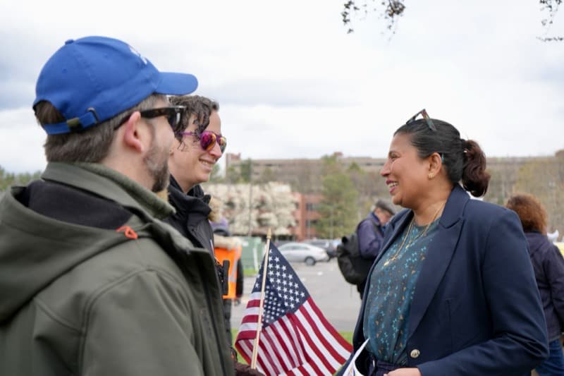 Dr. Harini Aiyer at a community rally with American flags